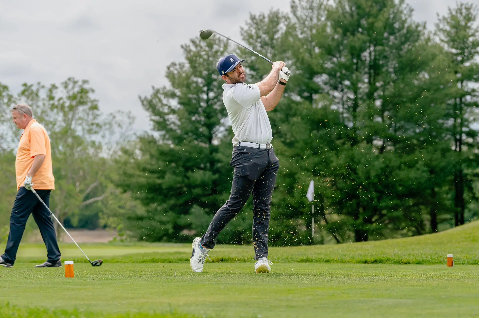 A golfer follows through on his tee shot at the Fairways for Hope tournament