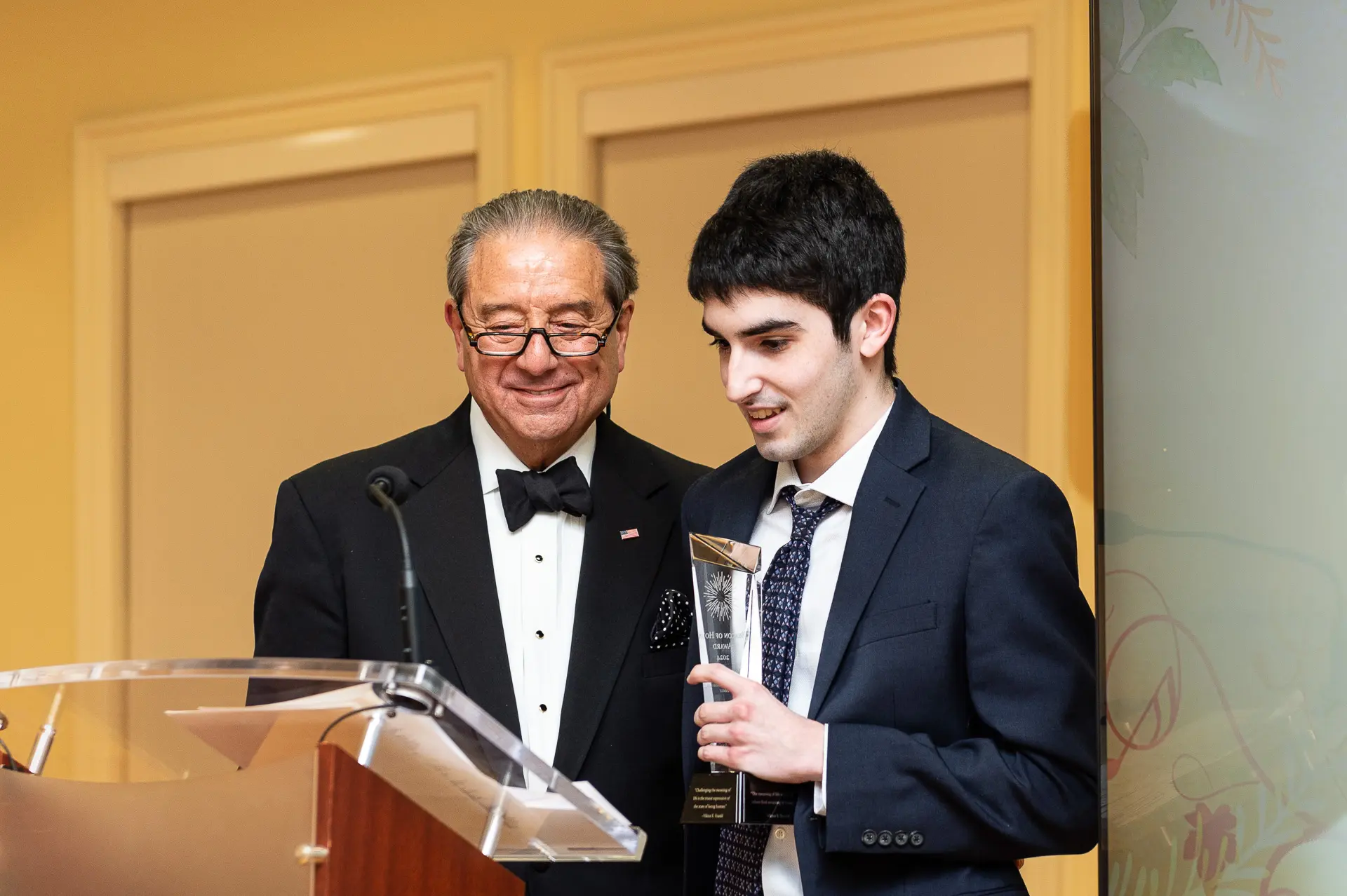 A Beacon of Hope Award recipient receiving their award on stage at the Notes of Hope Gala