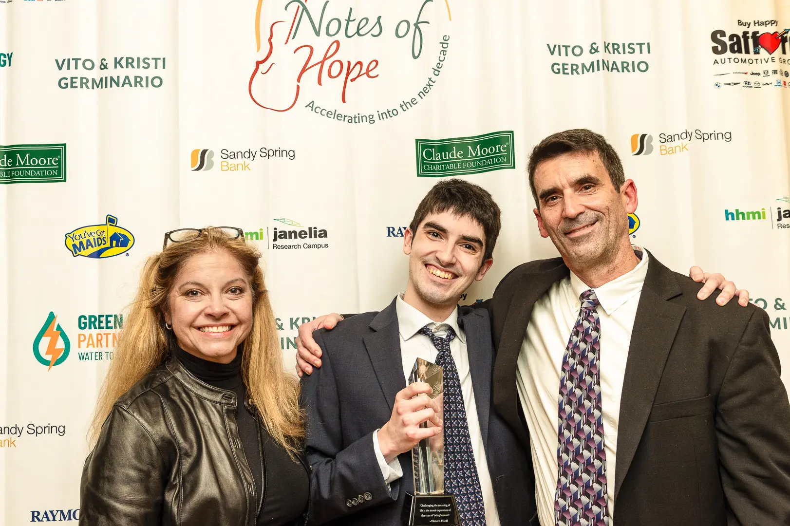 20241019_215429-1_Fundraise - The Ryan Bartel Foundation Supporters raising their hands during a fundraising moment at the Notes of Hope Gala