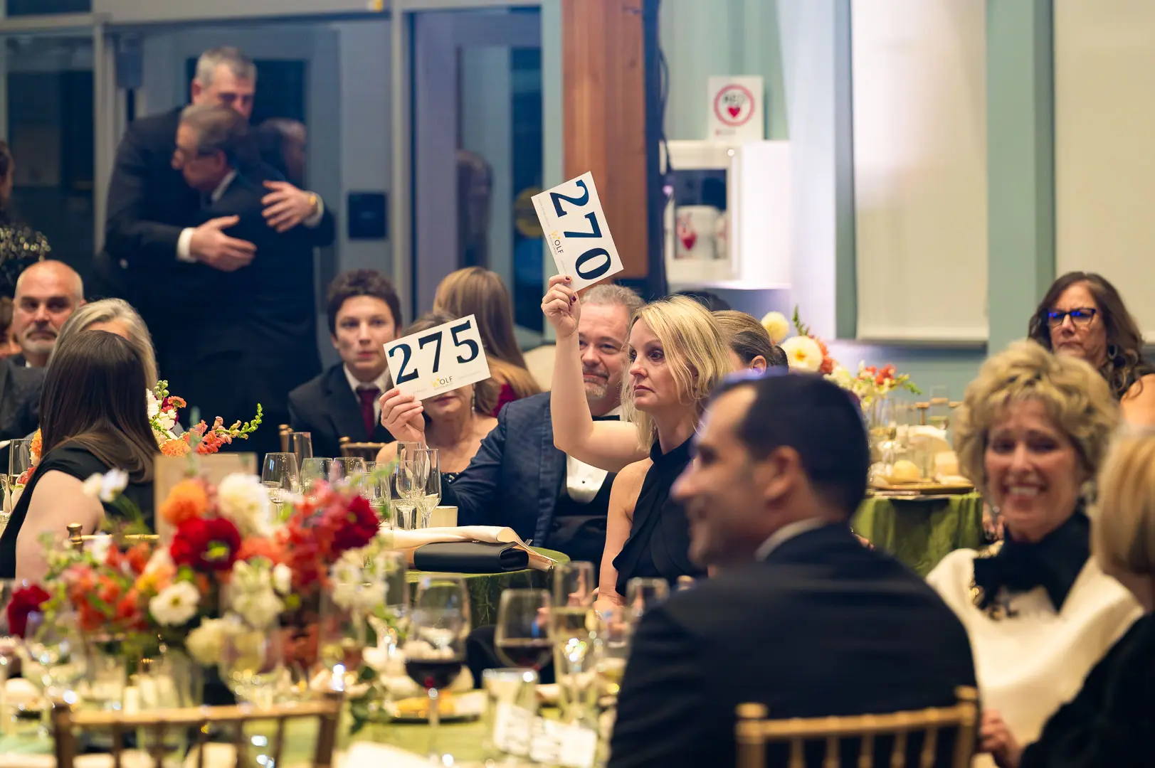 20251018-DSC_2458 - The Ryan Bartel Foundation Guests raising their bid paddles during the live auction at the Notes of Hope gala