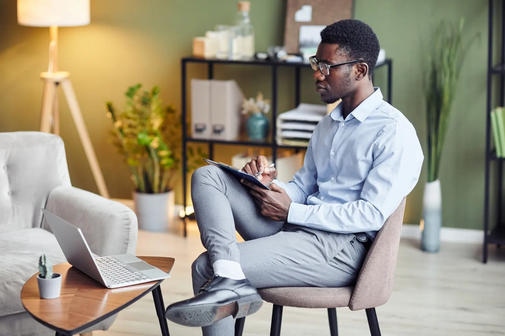 A clinician reviewing notes on a tablet while considering a client referral